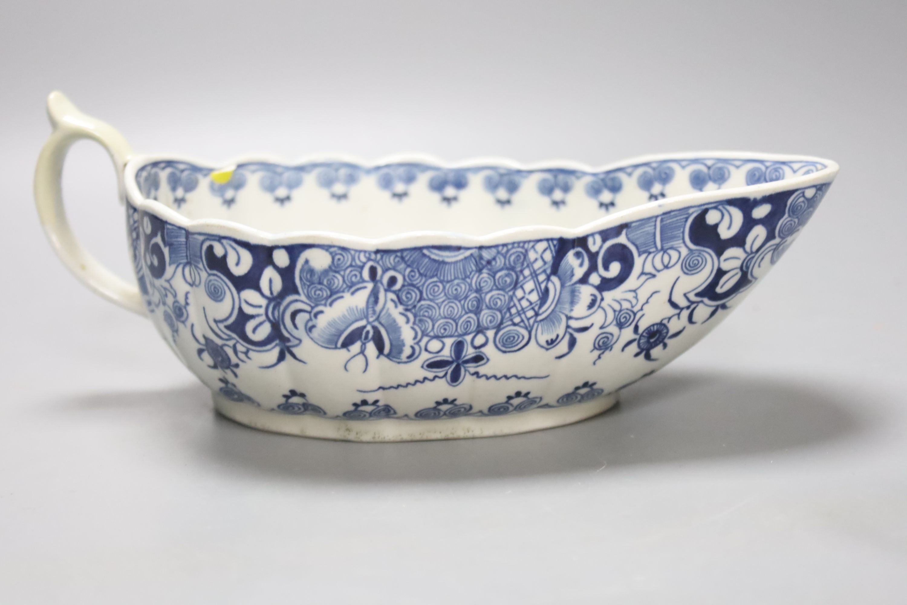 A Worcester Doughnut pattern blue and white sauceboat circa 1775 and two Chinese blue and white sauceboats, Qianlong period, longest 21cm